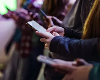 Close-up of mobile phones in children's hands