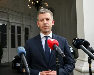 Péter Magyar speaks into media microphones