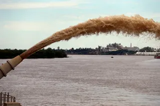 A dredging boat of the Luxembourg-based company Jan De Nul sprays sand at the shore on the Parana river near Rosario, Argentina. Photo: Reuters