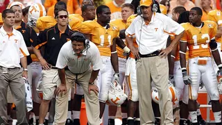 Ed Orgeron and Monte Kiffin standing on the sidelines at Neyland Stadium