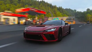 Forza Horizon 6 cars list: The 2025 GR GT Prototype racing down a rural street with a gas station in the background.