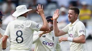 Stuart Broad and Ollie Robinson high-five each other while playing for England