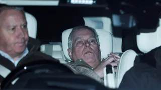 Prince Andrew seated in the back of a car after release from custody