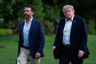 US President Donald Trump (right) walks across the South Lawn towards the White House with his son, Donald Trump Jnr, on May 3. Photo: EPA