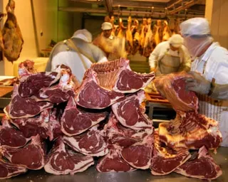 Beef carcasses being processed at a factory