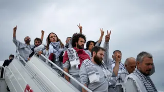 Activists from the Global Sumud Flotilla disembark a plane upon arriving at Istanbul Airport, in Istanbul, Turkey, Thursday, May 21, 2026