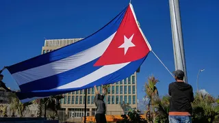 Workers flying Cuban flag at half-mast near U.S. embassy in Havana