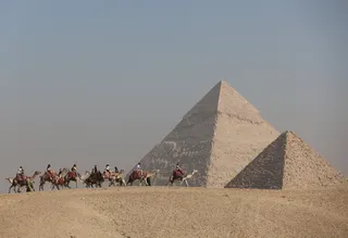Tourists ride camels in front of the Great Pyramids plateau in Giza, Egypt, in this file picture dated December 11, 2022. — Reuters pic