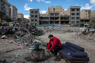 A man sits among buildings destroyed in Tehran in a joint attack by Israel and the United States on April 6. Photo: Getty Images
