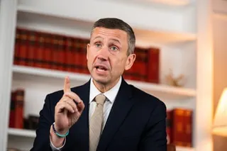 Ken Martin gestures with his finger raised while speaking in an office setting