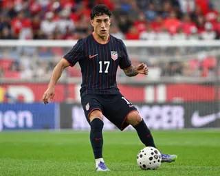 Alex Zendejas dribbles during a game.