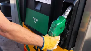 A semi truck driver replacing a diesel fuel pump at a Love's gas station in Eloy, Arizona