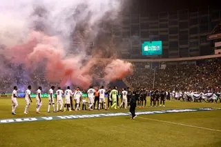 Mexico and Ghana players walk onto the pitch before the match