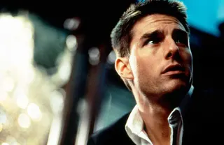 Tom Cruise in open necked shirt, looking up