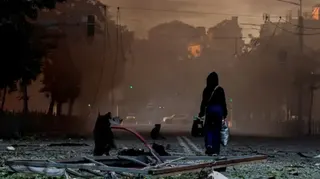 Reuters A person walks on a debris-scattered street in the aftermath of an overnight Russian missile and drone strike on Kyiv, Ukraine 24 May 2026.