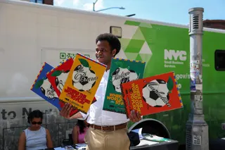 Jacques Brunvil of the NYC Department of Small Business Services holds up 2026 Fifa World Cup poster during an outreach event hosted by the NYC Department of Small Business Services in New York’s ‘Little Haiti’ neighbourhood on May 19, 2026. — AFP pic