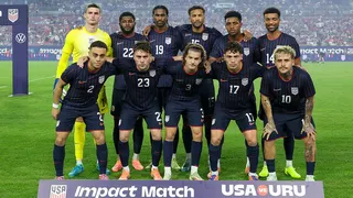 United States men's national soccer team posing for a group photo on the field