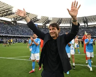 Antonio Conte waves to fans, alongside his players, after Napoli’s win over Udinese
