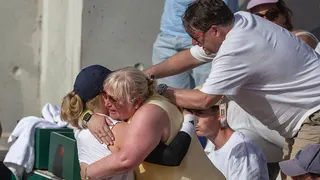 Francesca Jones of Great Britain is congratulated by her mother and father after her victory against Beatriz Haddad Maia