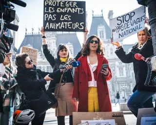 Co-founder of the #MeTooEcole collective, Barka Zerouali, centre, speaking at a press briefing in front of Paris city hall