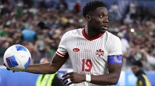Alphonso Davies of Canada takes a throw-in