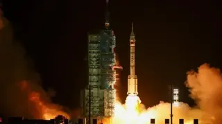 Reuters China's Shenzhou-23 launches into space at night, with its rocket boosters emitting gigantic flames and thick white smoke
