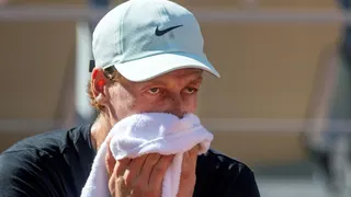 Jannik Sinner wipes his face with a towel during French Open practice