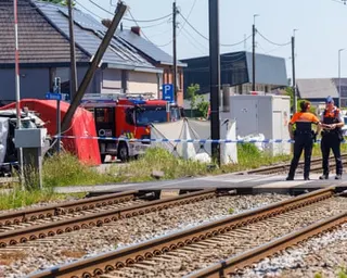 Two members of the emergency services stand on a crossing next to a cordon