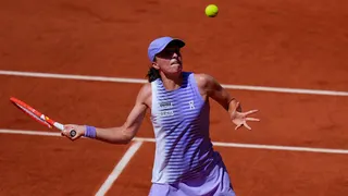 Iga Swiatek deals with a higher bouncing ball in her 6-1 6-2 win over Australia's Emerson Jones