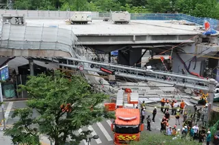 Rescuers search for victims after an overpass collapses in western Seoul on Tuesday. Photo: Yonhap/EPA