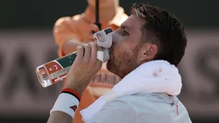 Cameron Norrie takes a drink of water