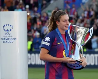 Alexia Putellas carries the Women's Champions League trophy before the trophy lift