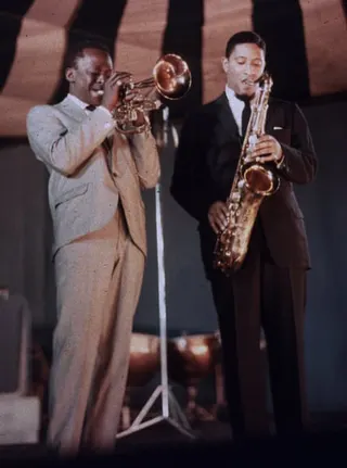 Miles Davis and Sonny Rollins perform together in 1957.