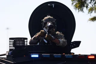 A law enforcement officer looks out from a vehicle during demonstrators’ standoff with US Immigration and Customs Enforcement (ICE) and federal officers. — Reuters file pic