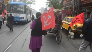 AFP via Getty Images Communist Party of India (CPI) activists stop vehicles along a road during a nationwide strike against new labour policies introduced by India's central government, in Kolkata.
