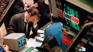 A stock trader puts his head in his hands.