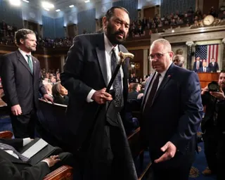 Man escorted from room