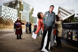 A protester holds life-size cardboard cut-outs of former Philippine president Rodrigo Duterte during a protest in his support outside the International Criminal Court in The Hague in February. Photo: AFP
