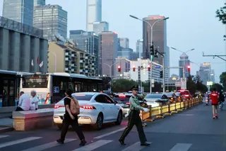 A paramilitary police officer crosses a street near Beijing’s central business district. Photo: Reuters