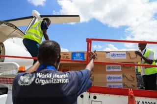 people load supplies onto a plane