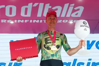 Michael Valgren poses on the podium after winning the 17th stage of the Giro d'Italia 2026