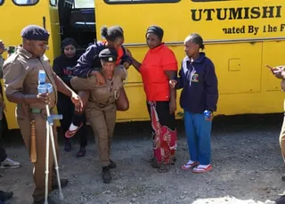 An injured Utumishi academy student is carried to safety.