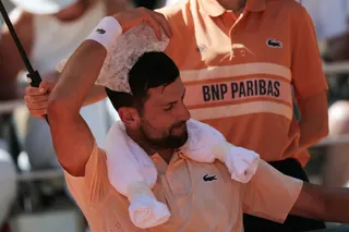 Serbia's Novak Djokovic uses an ice bag to cool off while sitting between games as he plays against  France's Valentin Royer during their men's singles match on day 4 of the French Open tennis tournament. — AFP pic