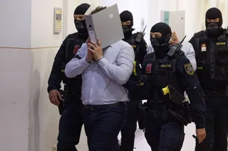 The defendant Beran A in the trial over alleged plans to attack a Taylor Swift concert in Vienna is escorted into the courtroom by police on Thursday. Photo: APA / dpa