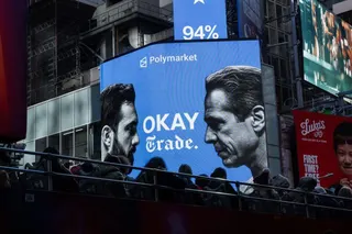 People walk past an electronic billboard showing candidates Zohran Mamdani and Andrew Cuomo