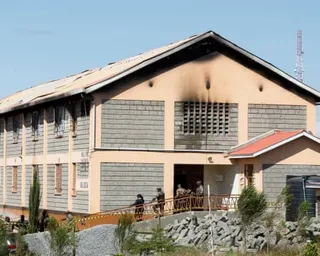 Security officers stand outside the fire-damaged dormitory at Utumishi girls academy in Gilgil.
