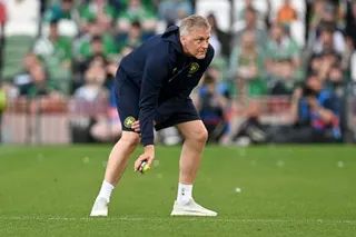 Heimir Hallgrimsson, Head Coach of Republic of Ireland, helps to clear tennis balls which have been thrown onto the pitch as a protest to an upcoming match between Republic of Ireland and Israel during the international friendly match between Republic of Ireland and Qatar
