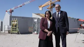 Home Secretary Shabana Mahmood with French Interior Minister, Laurent Nunez, on the site of a new detention centre that is being built in Dunkirk, France. Behind them there are partially constructed buildings and cranes.