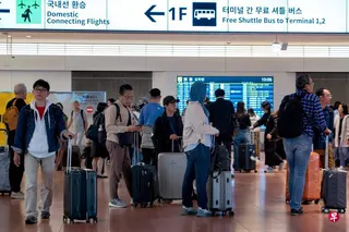 5月20日，旅客们抵达东京羽田机场的入境大厅。 （法新社）