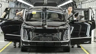 Employees inspect a Nio Inc. ES9 electric vehicle on the production line at the company's factory in Hefei, Anhui Province, China, on Tuesday, May 19, 2026.